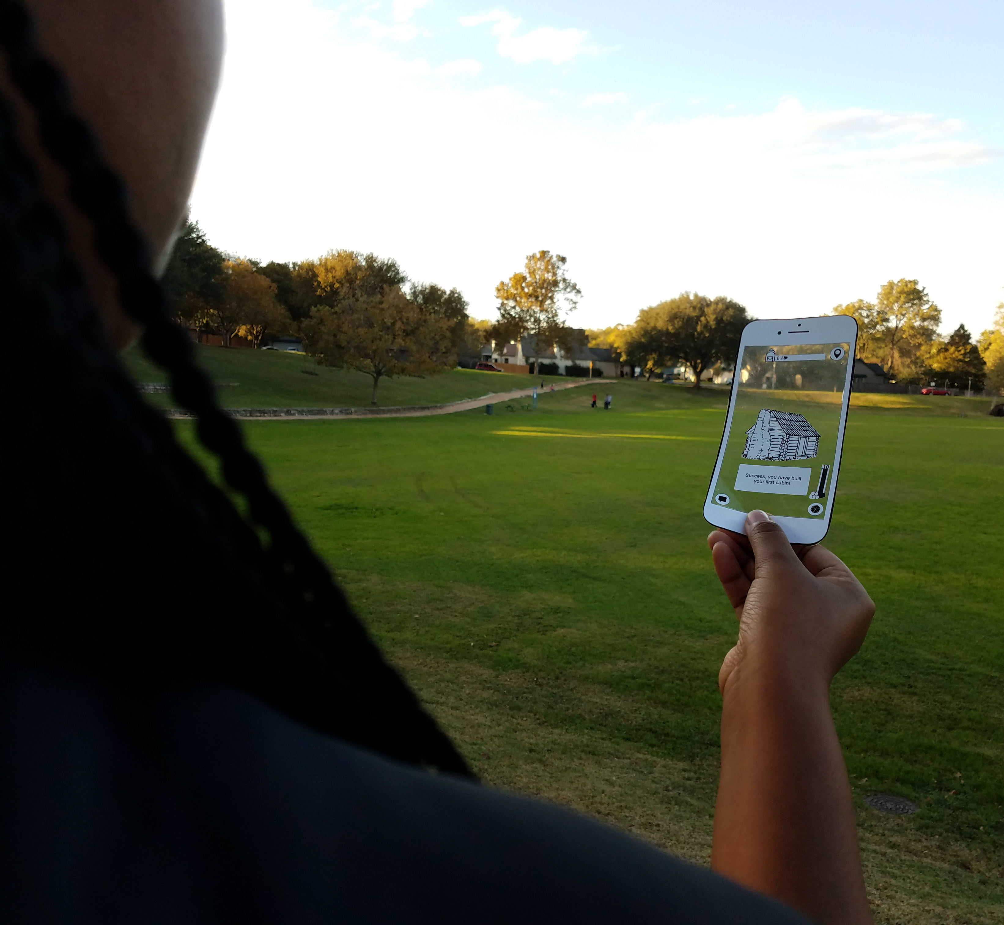 Someone holding a paper prototype of a smartphone game